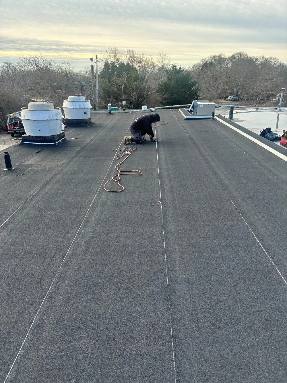 Hot-air welding the cap sheet of our modified bitumen roof.